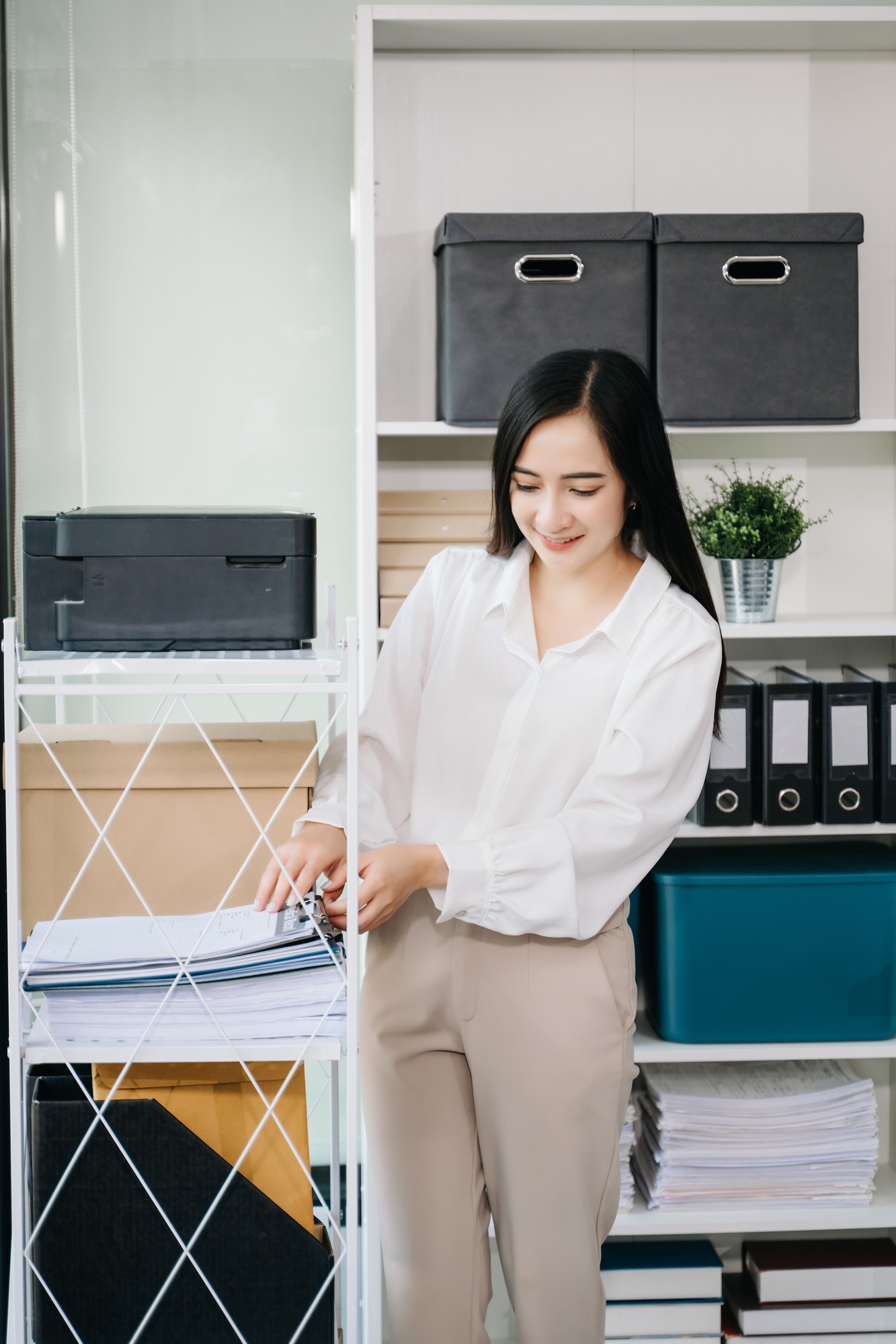 Asian Businesswoman Analyzing Finance on Tablet and Laptop at modern Office Desk tax